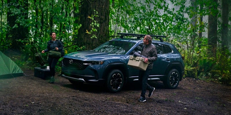 A CX-50 driving through a forest