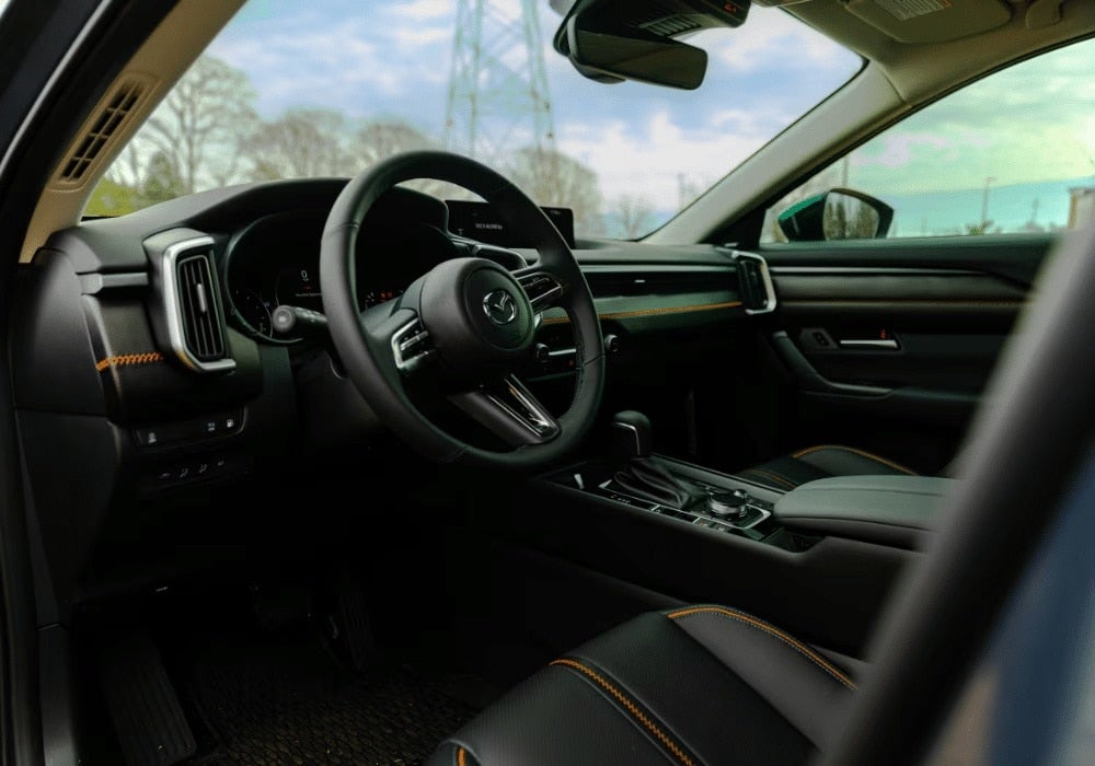 2025 Mazda CX-50 interior including the driver's seat, steering wheel, and front dash